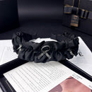 Side angle showing flexible curve and delicate crystal bow detail