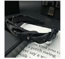 Back view of black satin headband showing secure fit and clean finish