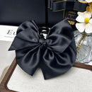 Close-up of hand-finished satin bow texture and stitching