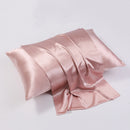 Dusty pink silk pillowcase styled on bed