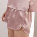 Lotus root pink silk shorts curved hem close-up