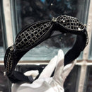 Close-up of hand-set rhinestones on matte black band surface