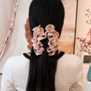 Ivory cloud clip placed at temple with soft face-framing layers