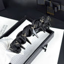 Black satin hair band worn on model's head, styled with loose waves and natural lighting