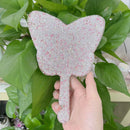 Mirror placed in open makeup bag showing compact travel-friendly fit