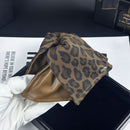 Close-up detail of embossed leopard pattern on leather-look claw clip