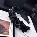 Close-up of hand-finished crystal-embellished satin bow