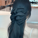 Close-up of handwoven black fabric texture and dimensional bow shaping