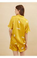 Close-up of elastic waistband on gold silk shorts