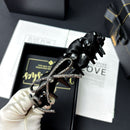 Close-up of hand-finished bow and sparkling crystal details on black satin headband