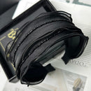 Front view of SUUMEE crystal mesh hair band in black on white background