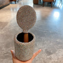 Canister opened to reveal interior space — showcasing capacity for small beauty items