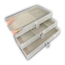 Open drawer revealing soft light-gray velvet lining and organized earring storage space