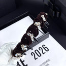 Close-up of hand-finished velvet texture and crystal placement on black variant