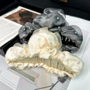 Sheer pearl hair claw clip on white background