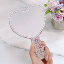 Close-up of sparkling white rhinestone border on round Suumee makeup mirror