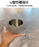 Ashtray in silver finish next to lit cigarette and ash collection for scale