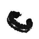 Close-up of delicate star embroidery on plush black velvet fabric