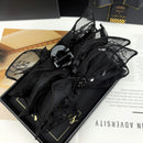 Side angle showing wide jaw and netting texture of black hair clip