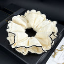 Side angle showing soft fabric drape and camellia floral detail