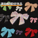 Front view of full-pavé bow rhinestone accent piece on white background