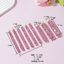 Flat lay of wooden brush handles with rhinestones next to cosmetic tools and brushes for styling reference