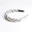 Side view of black cashew sponge headband showing thickness and flexibility