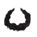 Black obsidian knot style headband laid flat showing clean silhouette and finish