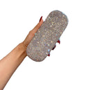 White eyeglass case placed beside a pair of modern rectangular eyeglasses for scale