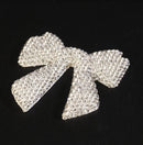 Bow accent on velvet display surface for luxury presentation