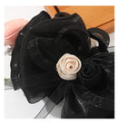 Black claw clip styled in a half-up, half-down hairstyle with face-framing layers