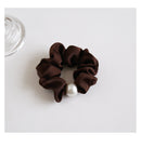 Macro texture shot highlighting smooth fabric and rounded pearl finish