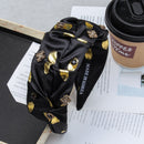 Side angle showing texture and rhinestone placement on emerald green headband