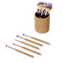 Hand holding contour brush applying product to cheekbone in natural lighting