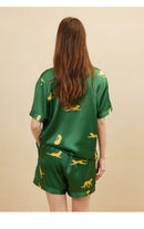 Full-length front view of dark green silk pajama set on model