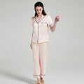 Close-up of notched collar and button details on silk pajama top