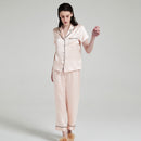 Close-up of notched collar and button details on silk pajama top