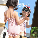 The suspender one-piece swimsuit is cute and playful
